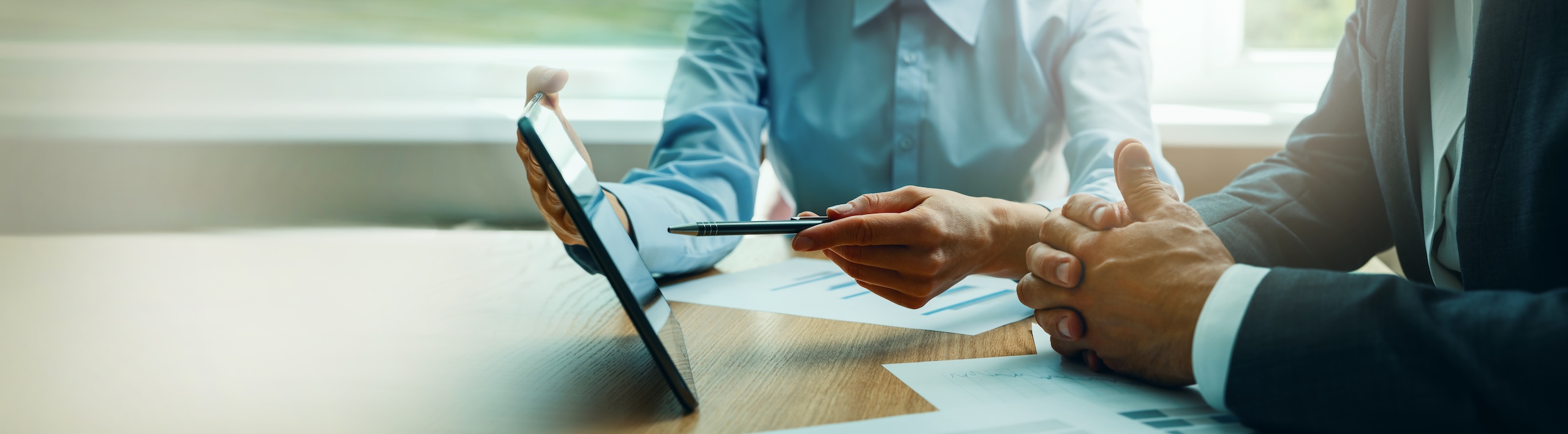 business consulting services. advisor and businessman working with digital tablet at desk in office. corporate strategy